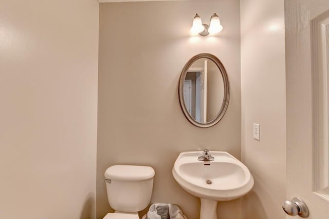 bathroom featuring toilet and sink