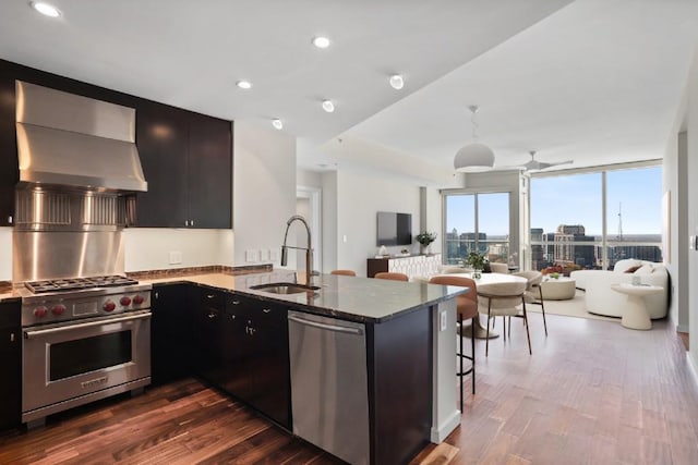 3325 Piedmont Rd NE Unit 2104, Atlanta, GA 30305 - kitchen featuring stainless steel appliances, a sink, open floor plan, dark stone counters, and dark wood-style floors