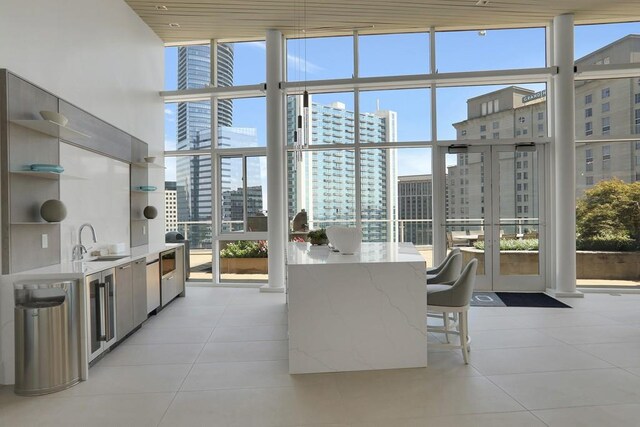 3325 Piedmont Rd NE Unit 2104, Atlanta, GA 30305 - kitchen featuring expansive windows, a city view, open shelves, light tile patterned floors, and modern cabinets