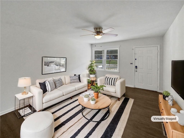 living area with wood finished floors, baseboards, and ceiling fan