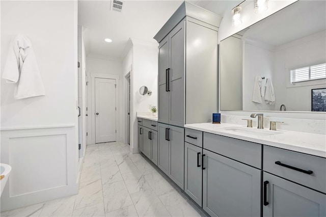 bathroom featuring crown molding and vanity