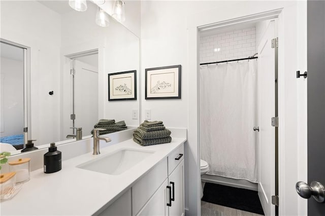 bathroom with vanity, a shower with curtain, and toilet