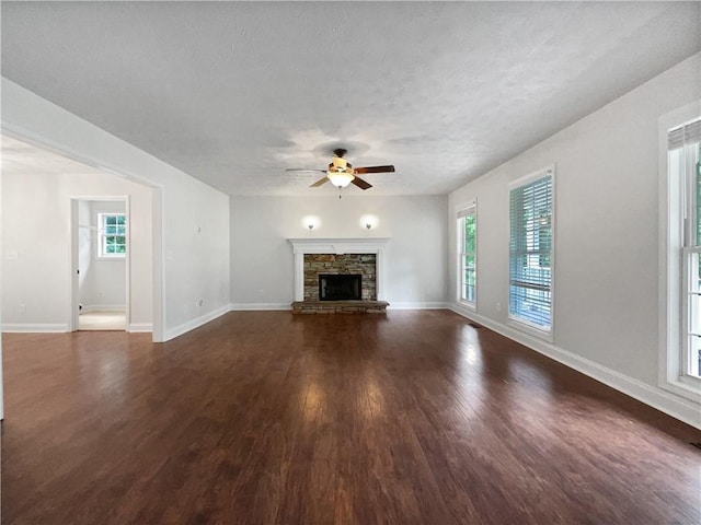 643 Windy Mill Way, Temple, GA 30179 - unfurnished living room featuring ceiling fan, wood finished floors, a fireplace, and a textured ceiling