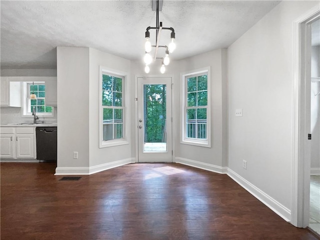 643 Windy Mill Way, Temple, GA 30179 - doorway to outside featuring a chandelier, dark wood-type flooring, and a textured ceiling