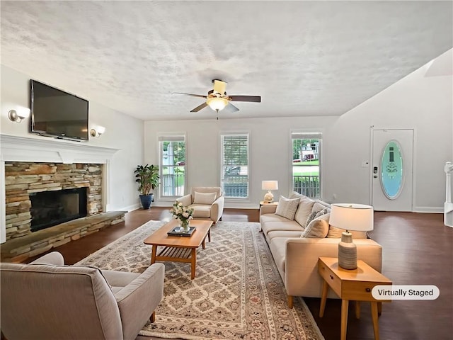 643 Windy Mill Way, Temple, GA 30179 - living area featuring wood finished floors, a ceiling fan, a textured ceiling, and a fireplace