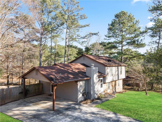 view of home's exterior with a carport and a yard