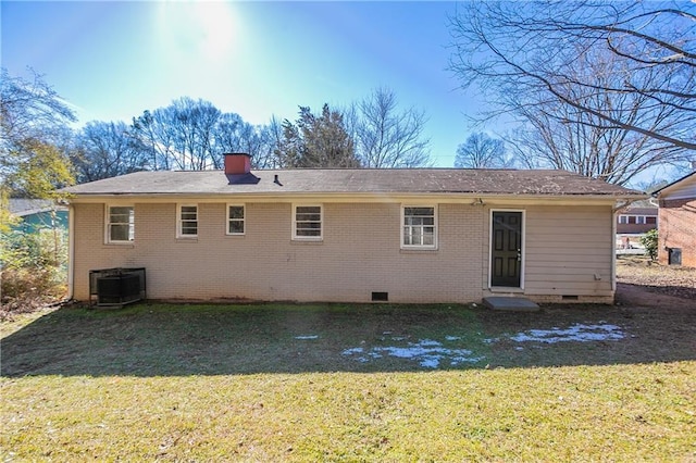 back of property with a yard and central air condition unit