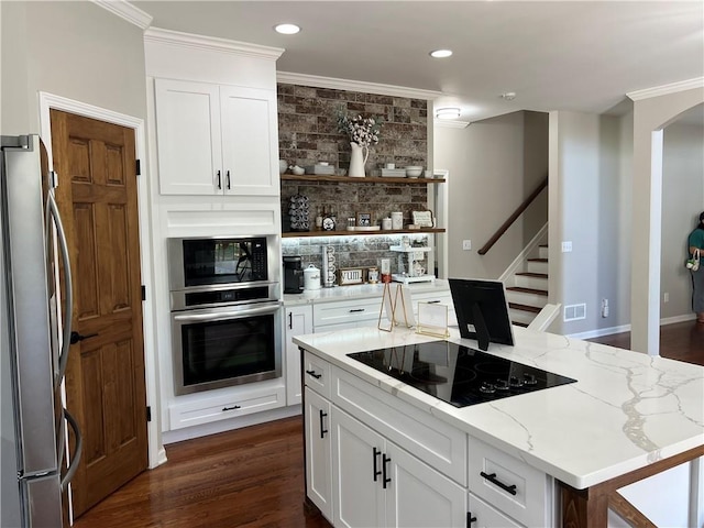 434 Beachwood Dr, Cornelia, GA 30531 - kitchen featuring black appliances, ornamental molding, light stone countertops, a center island, and open shelves