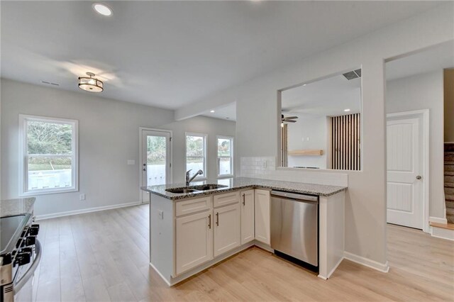 kitchen featuring white cabinetry, appliances with stainless steel finishes, sink, and a wealth of natural light