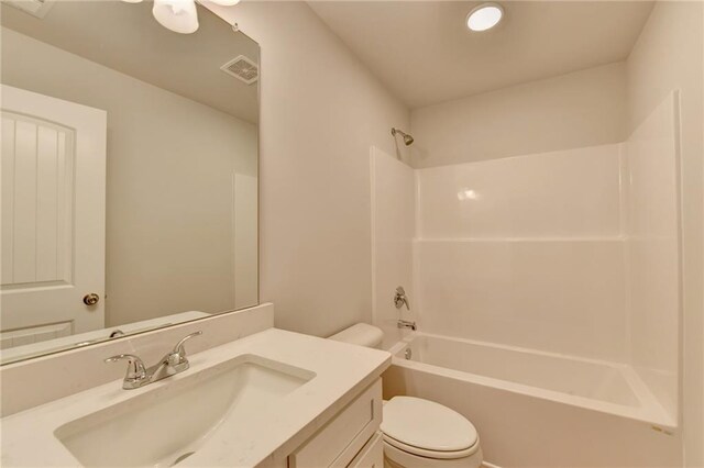 full bathroom featuring toilet, vanity, and tub / shower combination