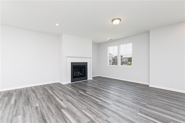 unfurnished living room with hardwood / wood-style floors