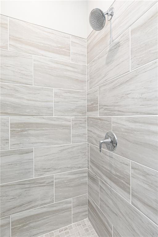 bathroom with tiled shower