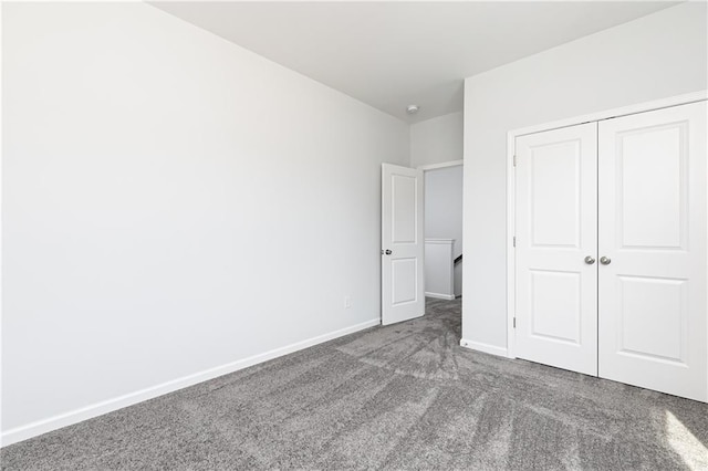 unfurnished bedroom with carpet and a closet