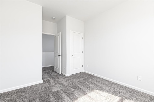 unfurnished bedroom featuring dark colored carpet