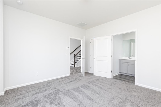 carpeted spare room with sink