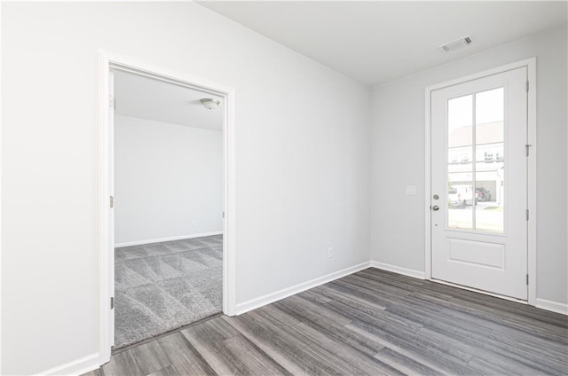 unfurnished room with a healthy amount of sunlight and wood-type flooring