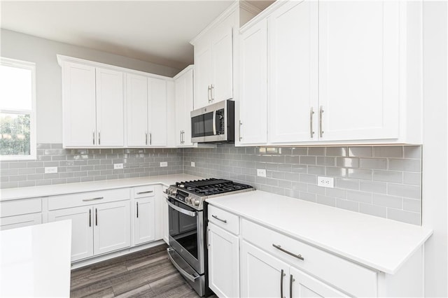 kitchen with white cabinets, backsplash, and stainless steel appliances