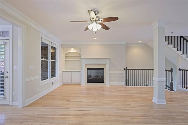 unfurnished living room with a ceiling fan, a fireplace with flush hearth, crown molding, baseboards, and light wood finished floors
