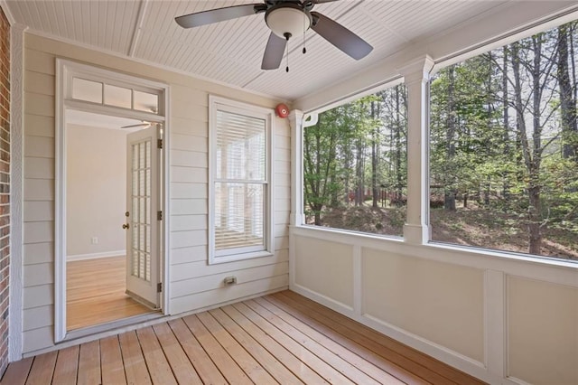 unfurnished sunroom with ceiling fan and a wealth of natural light