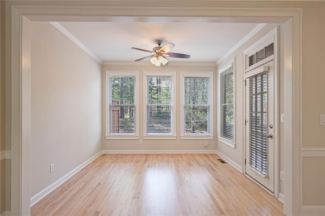 interior space featuring crown molding, ceiling fan, baseboards, and light wood-type flooring