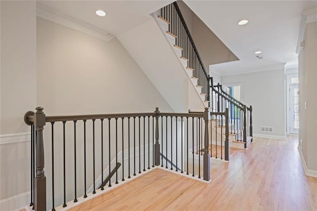 hall featuring crown molding, recessed lighting, baseboards, and wood finished floors