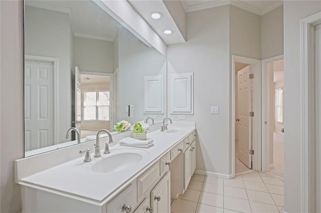 bathroom featuring crown molding, a sink, and tile patterned flooring