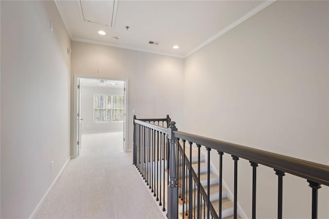 corridor with light carpet, attic access, baseboards, an upstairs landing, and visible vents