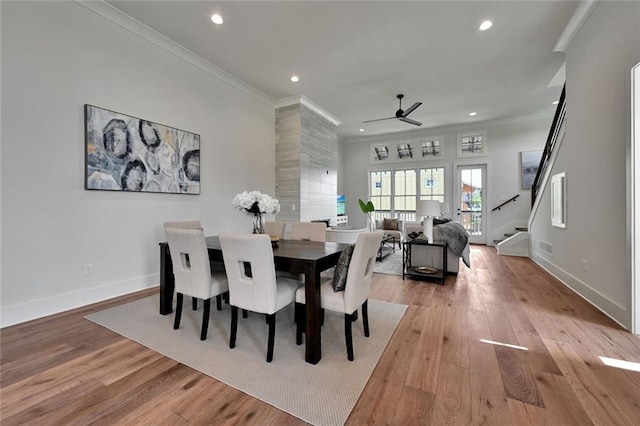 dining room featuring light wood-type flooring, ceiling fan, and ornamental molding