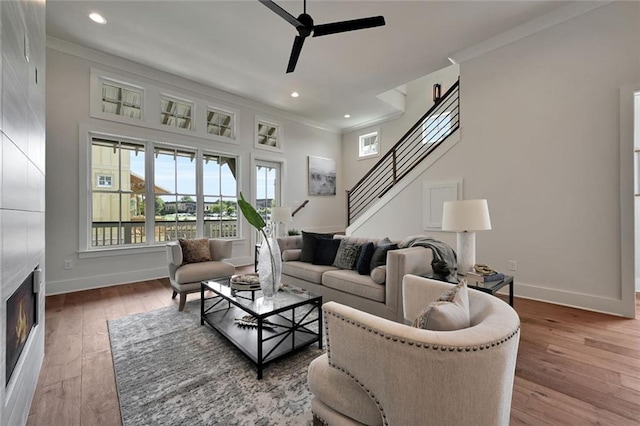 living room featuring plenty of natural light, hardwood / wood-style floors, and crown molding