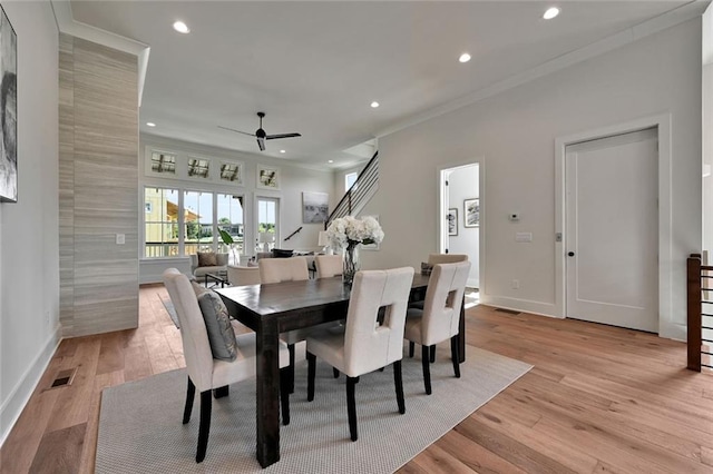 dining room with crown molding, light wood-type flooring, and ceiling fan