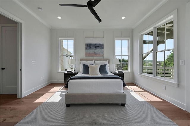 bedroom with light hardwood / wood-style flooring, ceiling fan, and ornamental molding