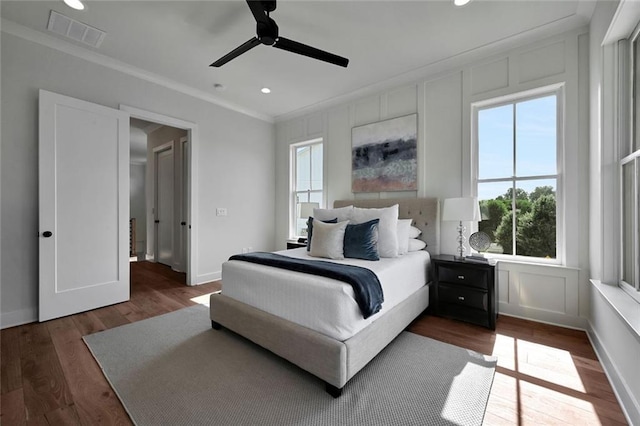 bedroom featuring ceiling fan, crown molding, and dark hardwood / wood-style flooring