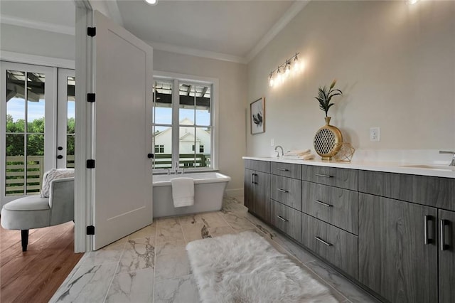 bathroom featuring vanity, a bathtub, and crown molding