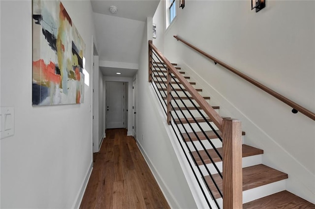 stairs featuring hardwood / wood-style floors