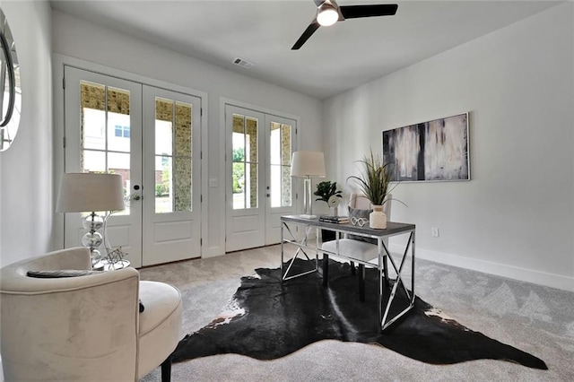 office with ceiling fan, french doors, and light colored carpet