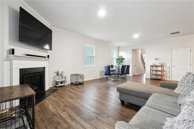6004 Screech Owl Dr, Flowery Branch, GA 30542 - living room featuring crown molding, wood finished floors, stairs, baseboards, and a fireplace with raised hearth
