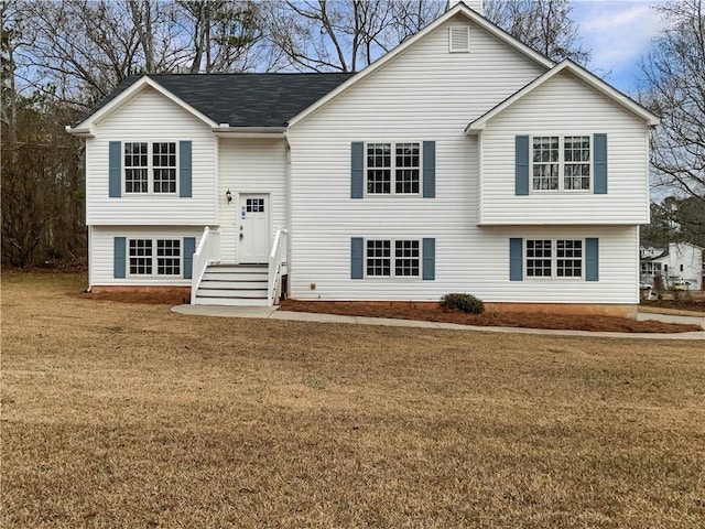 split foyer home featuring a front lawn