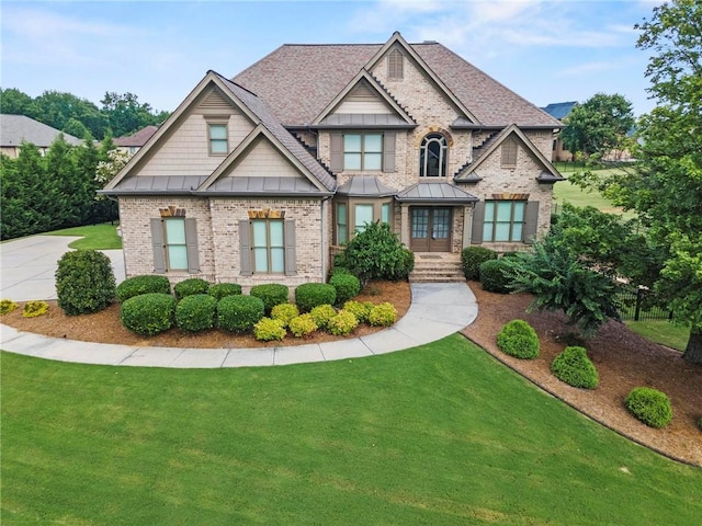 2602 Alcovy Club Dr, Dacula, GA 30019 - craftsman inspired home with a front yard, brick siding, a standing seam roof, and french doors