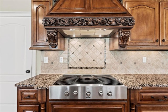 2602 Alcovy Club Dr, Dacula, GA 30019 - kitchen featuring stainless steel gas stovetop, tasteful backsplash, light stone countertops, and premium range hood
