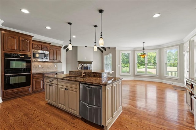2602 Alcovy Club Dr, Dacula, GA 30019 - kitchen featuring appliances with stainless steel finishes, crown molding, light wood-style flooring, decorative backsplash, and dark stone counters