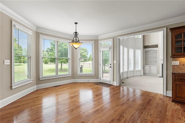 2602 Alcovy Club Dr, Dacula, GA 30019 - unfurnished dining area with crown molding and wood finished floors
