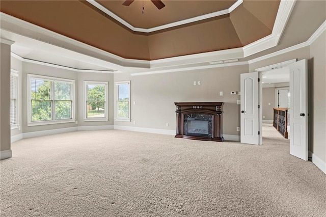 2602 Alcovy Club Dr, Dacula, GA 30019 - unfurnished living room featuring a tray ceiling, carpet floors, a premium fireplace, crown molding, and a ceiling fan