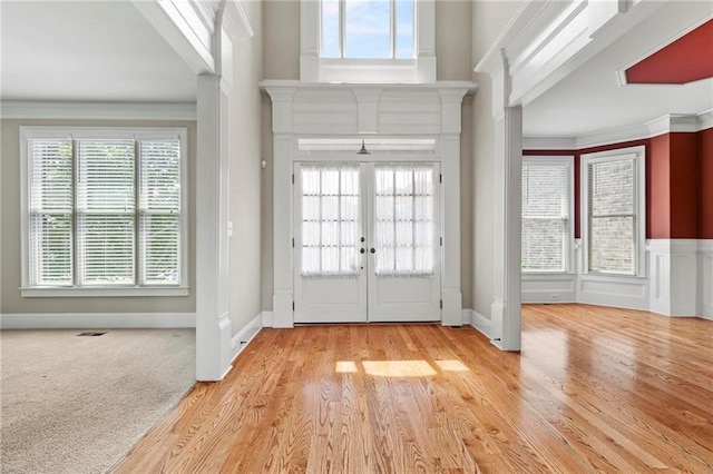 2602 Alcovy Club Dr, Dacula, GA 30019 - foyer entrance with healthy amount of natural light, wood finished floors, french doors, a wainscoted wall, and ornamental molding