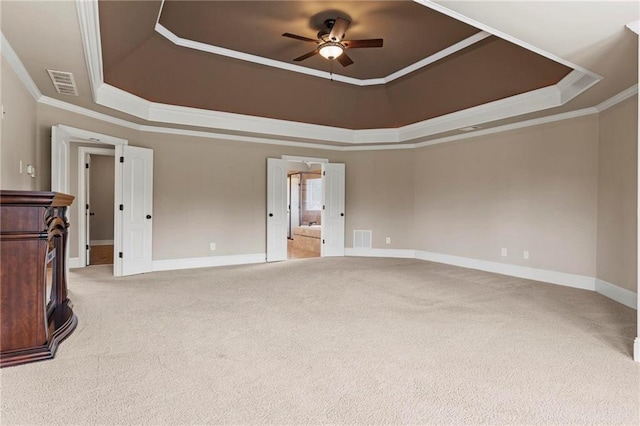 2602 Alcovy Club Dr, Dacula, GA 30019 - unfurnished bedroom with a tray ceiling, light colored carpet, crown molding, and a ceiling fan