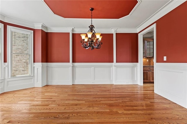 2602 Alcovy Club Dr, Dacula, GA 30019 - unfurnished dining area featuring a chandelier, wood finished floors, a wainscoted wall, a decorative wall, and crown molding