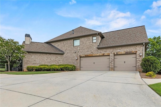 2602 Alcovy Club Dr, Dacula, GA 30019 - view of property exterior with concrete driveway, brick siding, a shingled roof, and a chimney