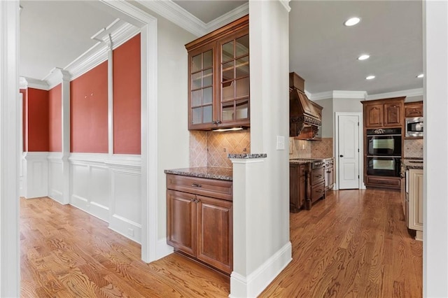 2602 Alcovy Club Dr, Dacula, GA 30019 - hallway with light wood-style flooring, crown molding, recessed lighting, and wainscoting