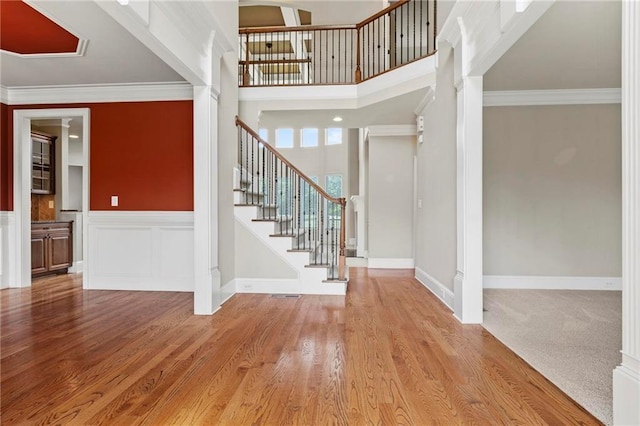2602 Alcovy Club Dr, Dacula, GA 30019 - entrance foyer with stairway, wood finished floors, ornamental molding, and wainscoting