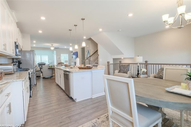 2247 Pink Hawthorn Dr, Buford, GA 30518 - kitchen featuring open floor plan, stainless steel appliances, a chandelier, white cabinets, and recessed lighting