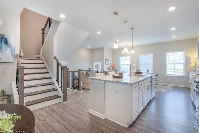 2247 Pink Hawthorn Dr, Buford, GA 30518 - kitchen with white cabinetry, light wood finished floors, healthy amount of natural light, light stone countertops, and recessed lighting